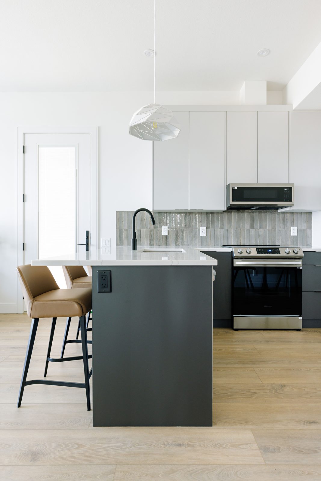 Grey island kitchen with white uppers
