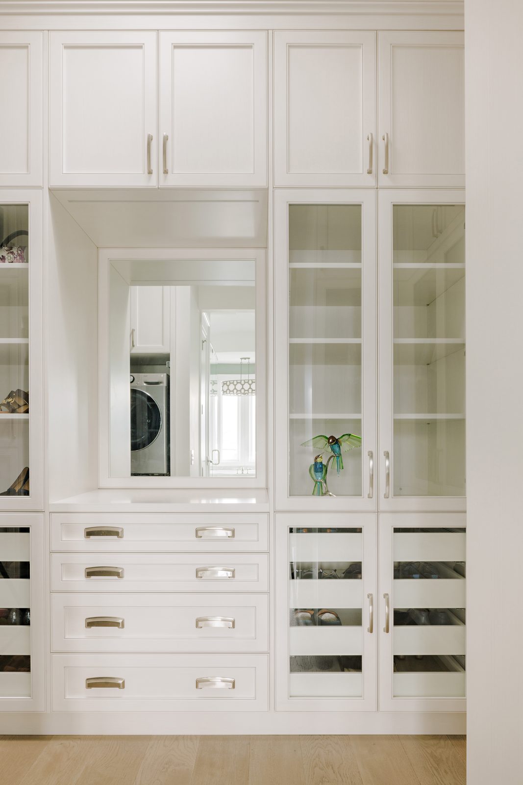 Custom closet millwork with glass fronts