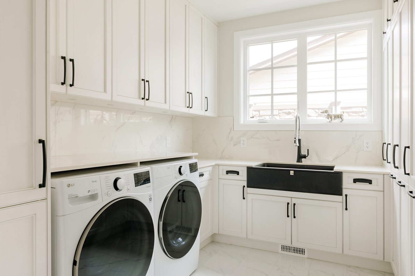 White laundry millwork with farmhouse sink