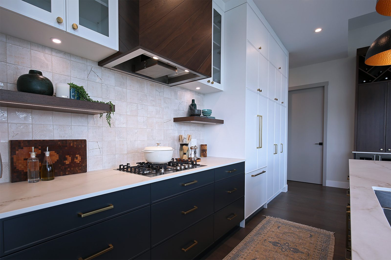 Navy millwork kitchen with wood hood