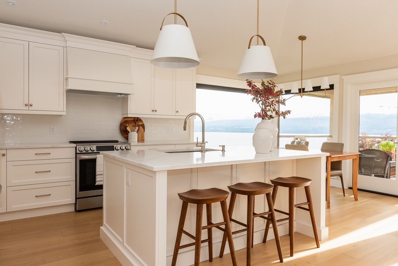 White millwork kitchen with lake view