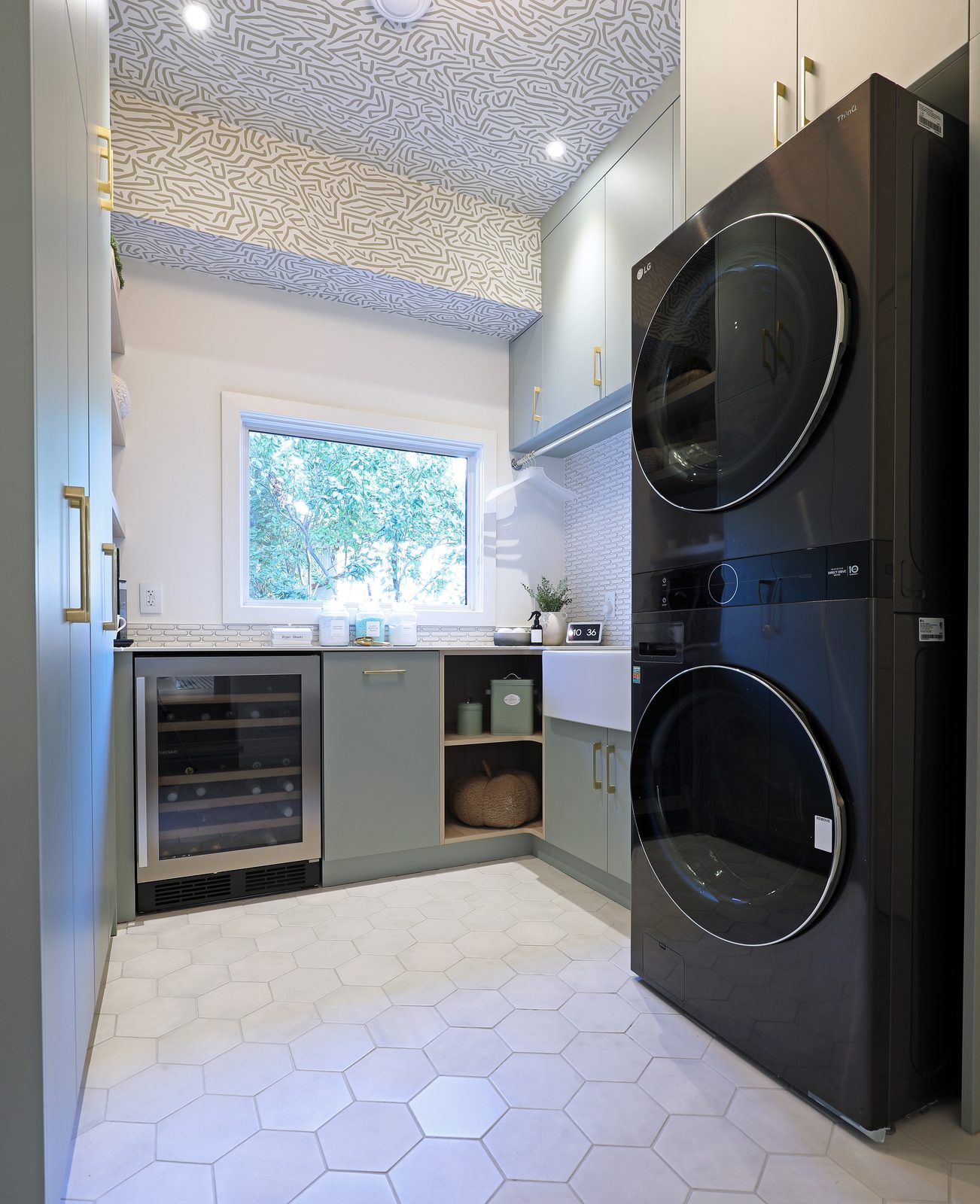 Sage laundry millwork with stacked appliances