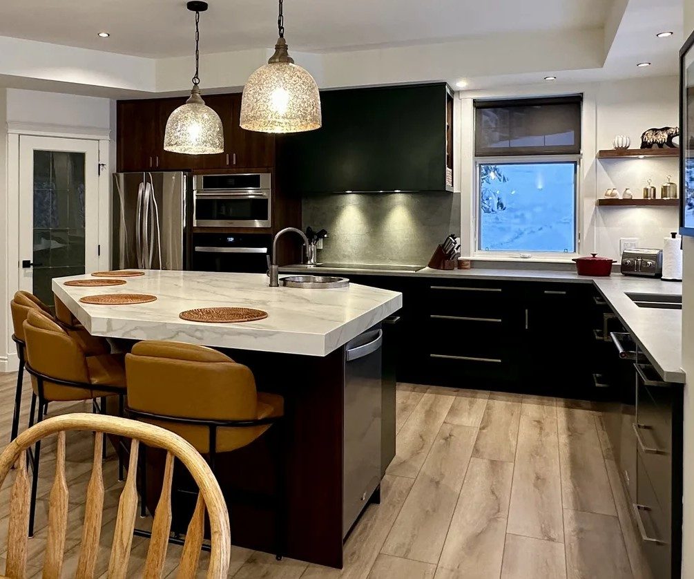 Dark millwork kitchen with marble island